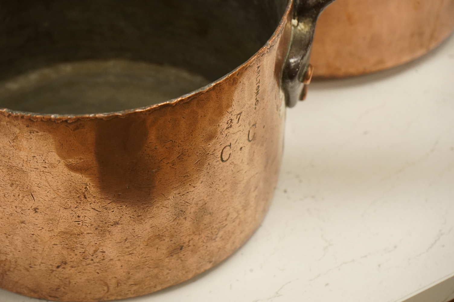 A graduated group of four large copper saucepans